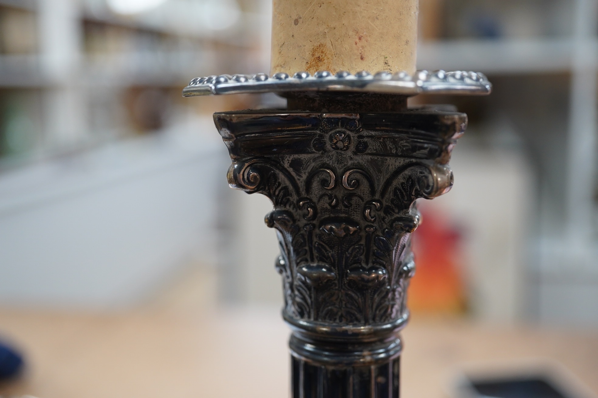 A pair of late Victorian silver Corinthian column candlesticks, now drilled for electricity and converted to lamps, James Dixon & Sons, Ltd, Sheffield, 1894, sticks only 21.8cm, weighted. Condition - poor